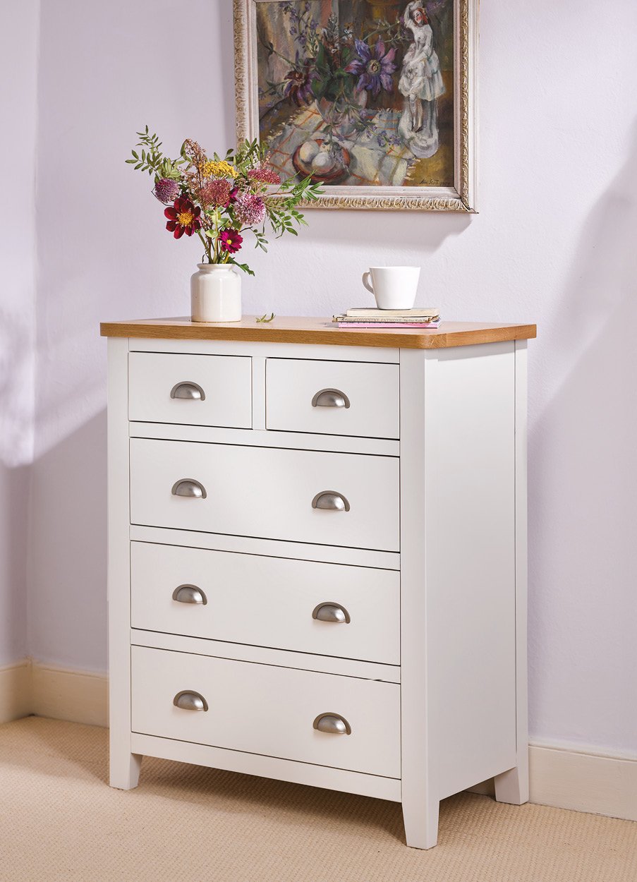 White 5 drawer unit with vase of flowers