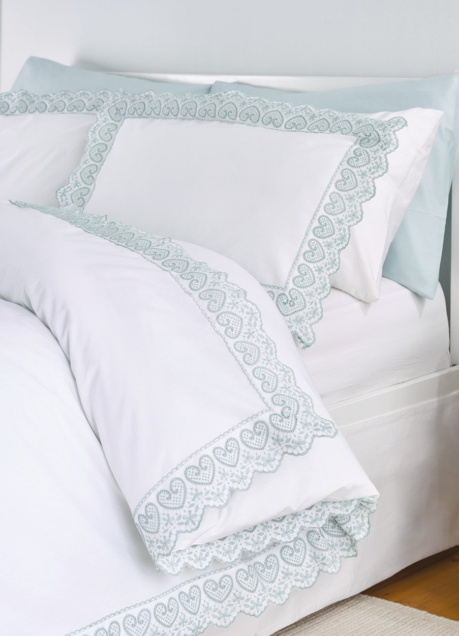 White bedlinen with green embroidered edging 