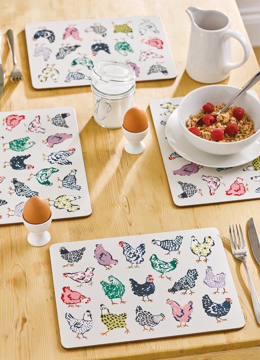 4 placemats with chicken design on a laid breakfast table