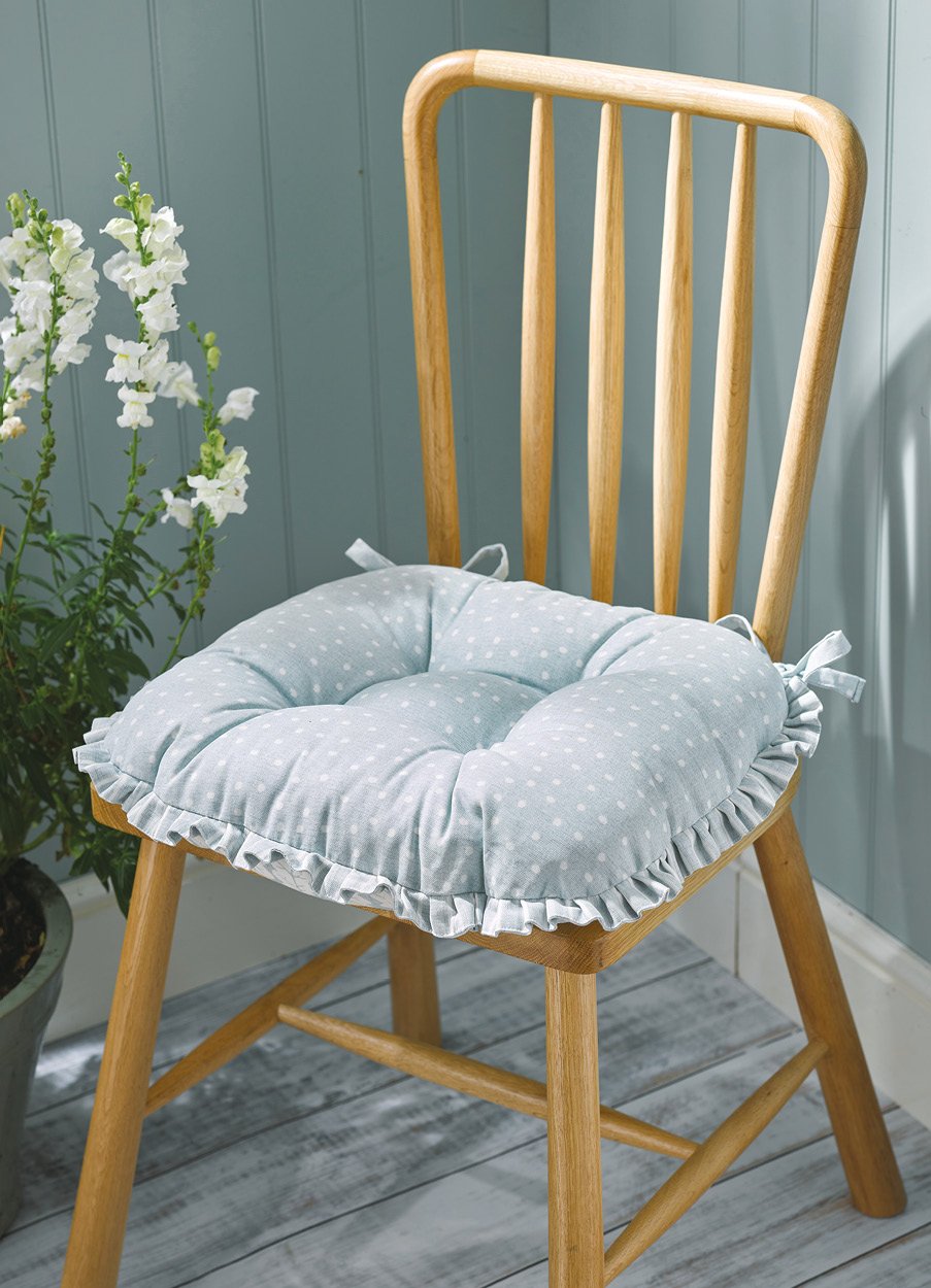 Wooden chair with ruffle seat pad on
