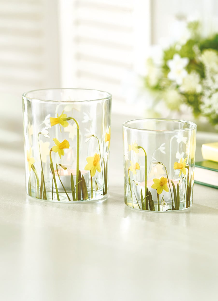 Two glass tealight holders with daffodils painted on