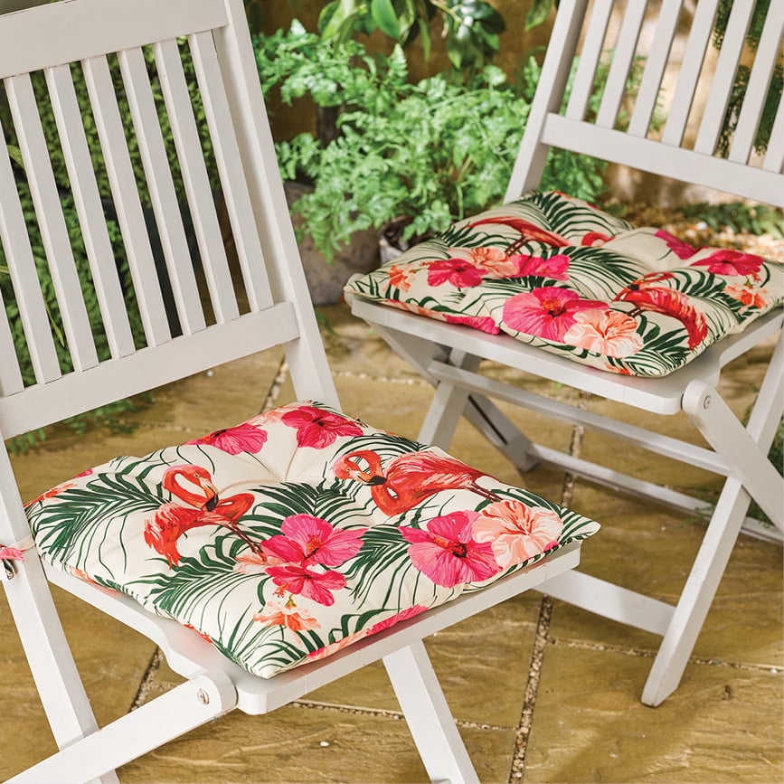 White garden chairs with bright floral cushions