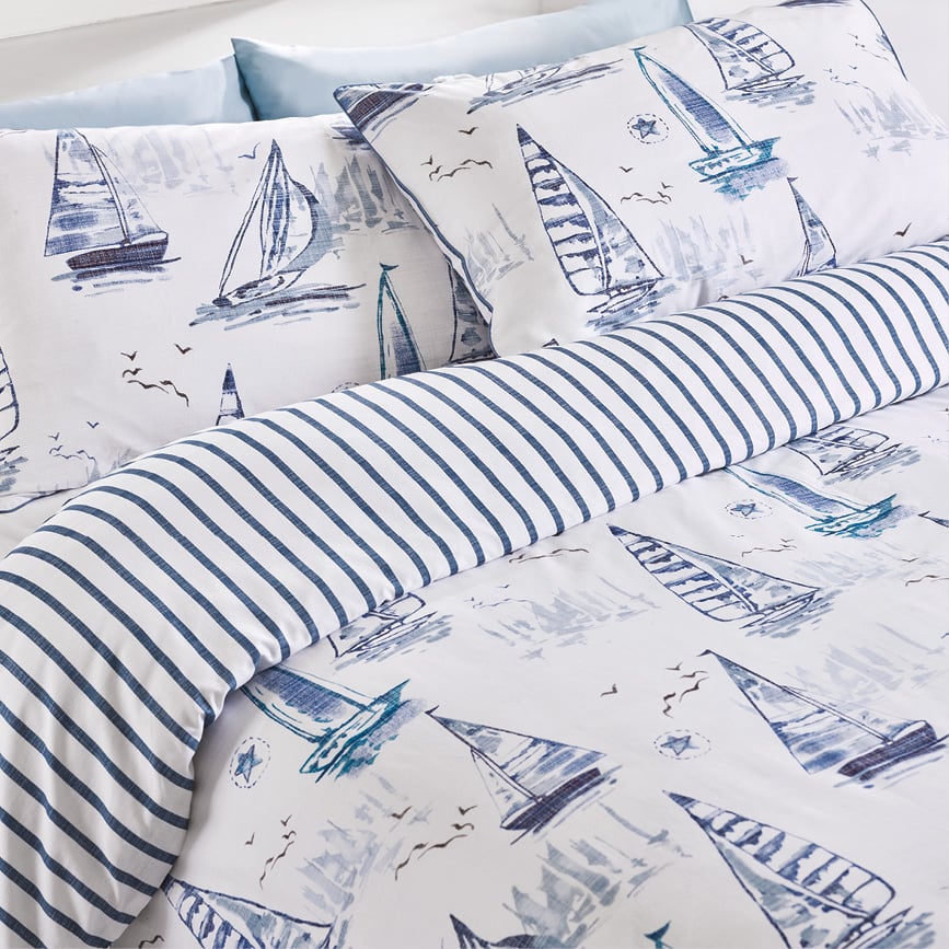 Sailboat bedding set with pillows on bed