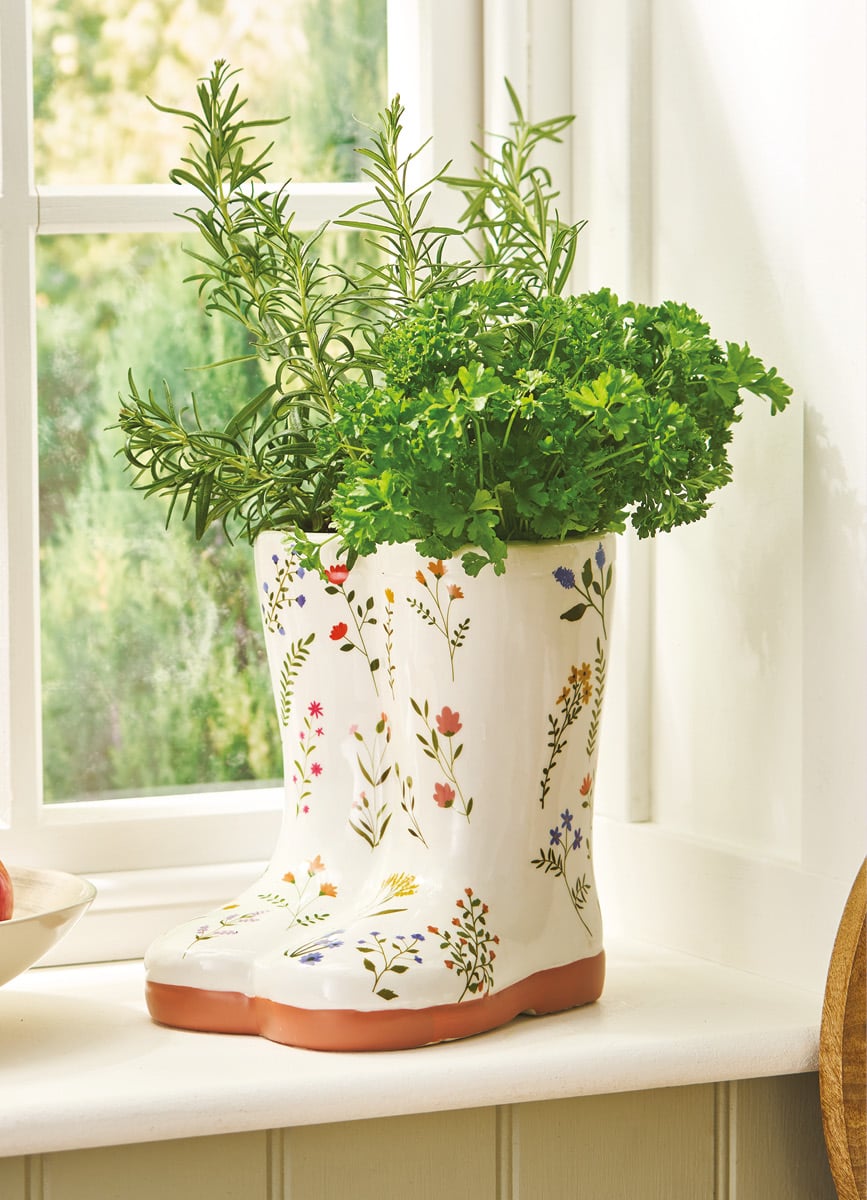 Floral design welly vase with greenery inside