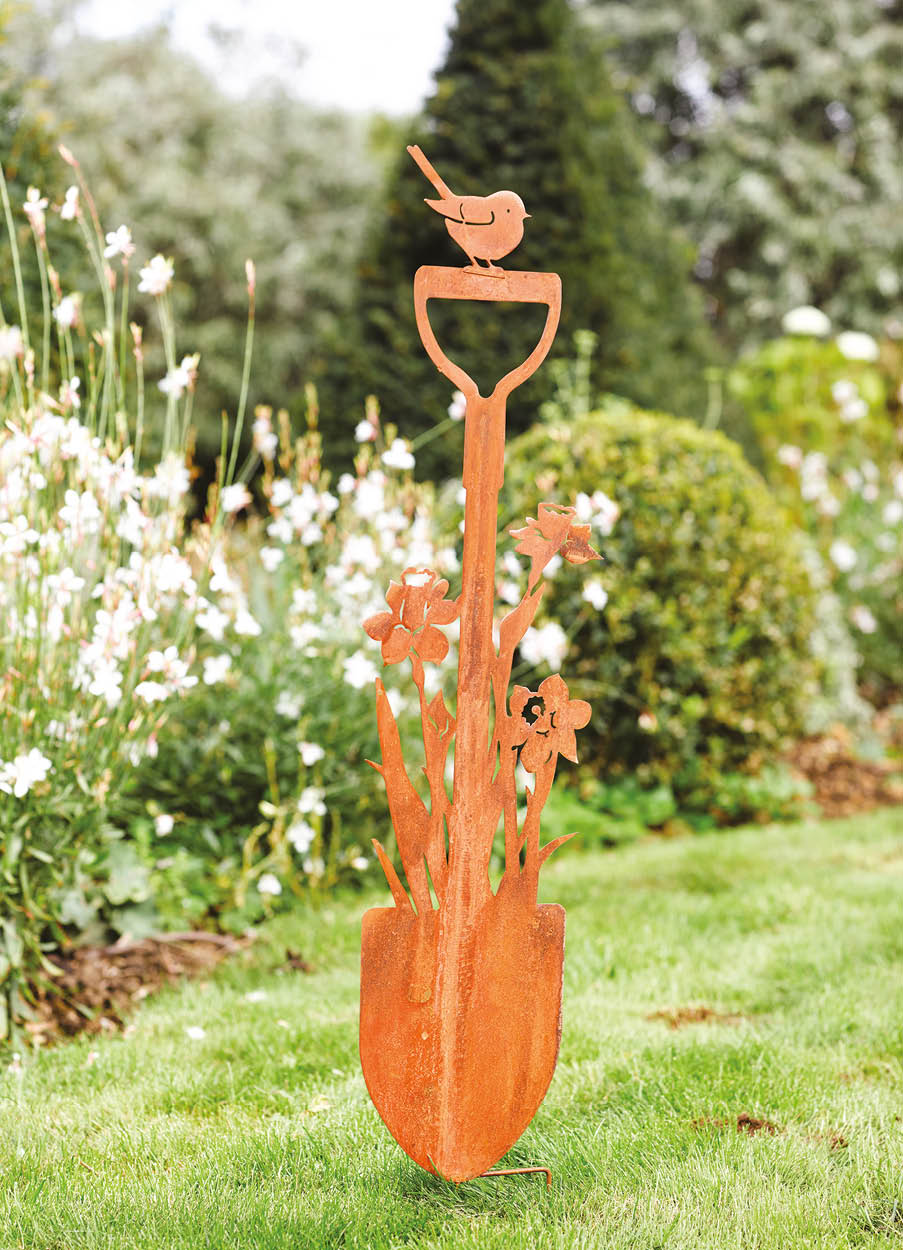 Rustic garden stake shaped like a shovel with daffodils