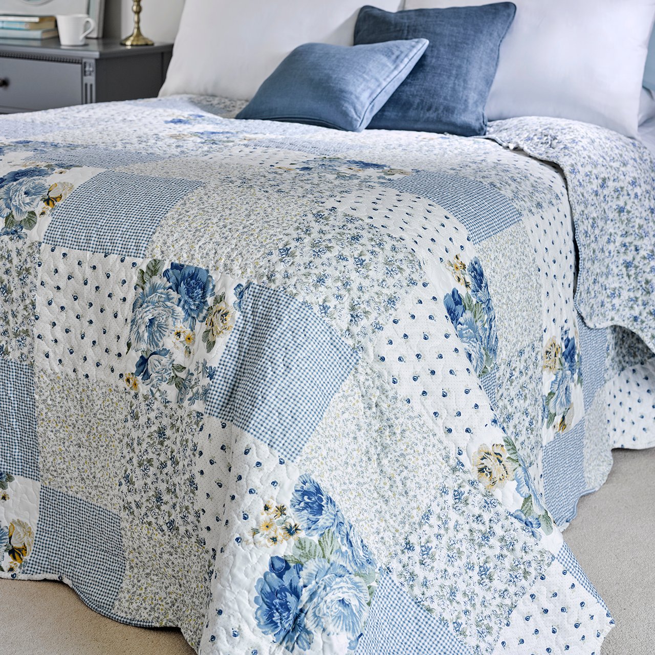 Blue patchwork bedspread on a bed
