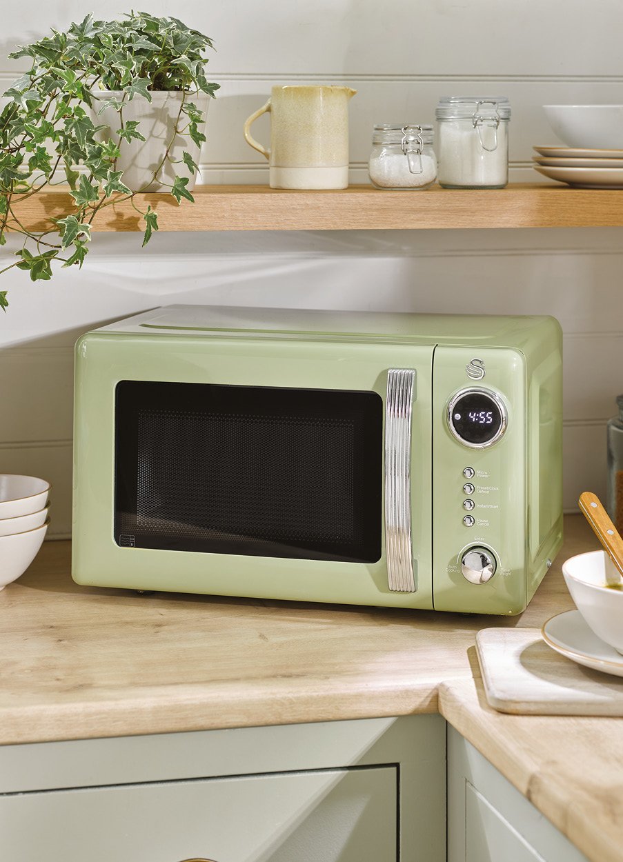 Sage green retro style microwave on worktop