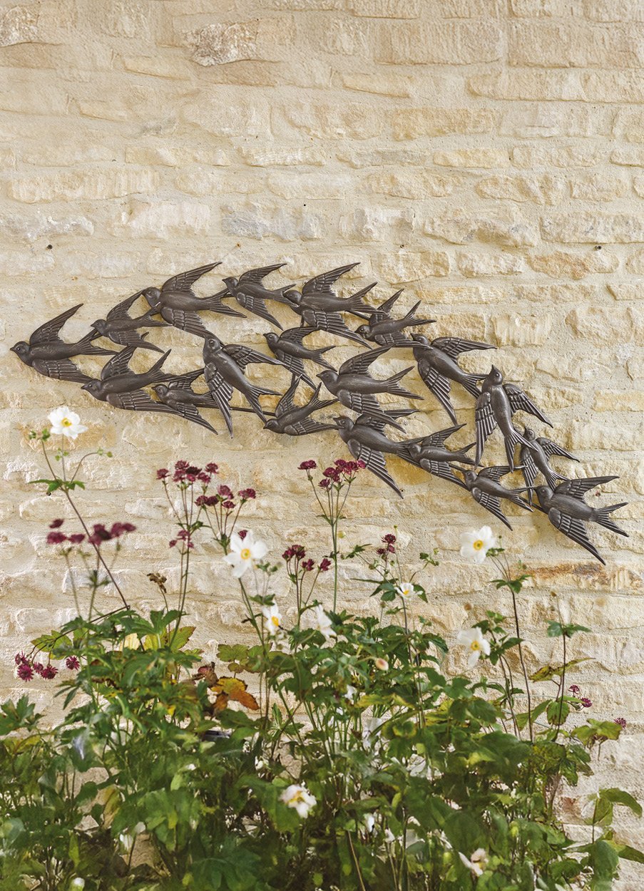 Metal garden wall art showing swallows in formation