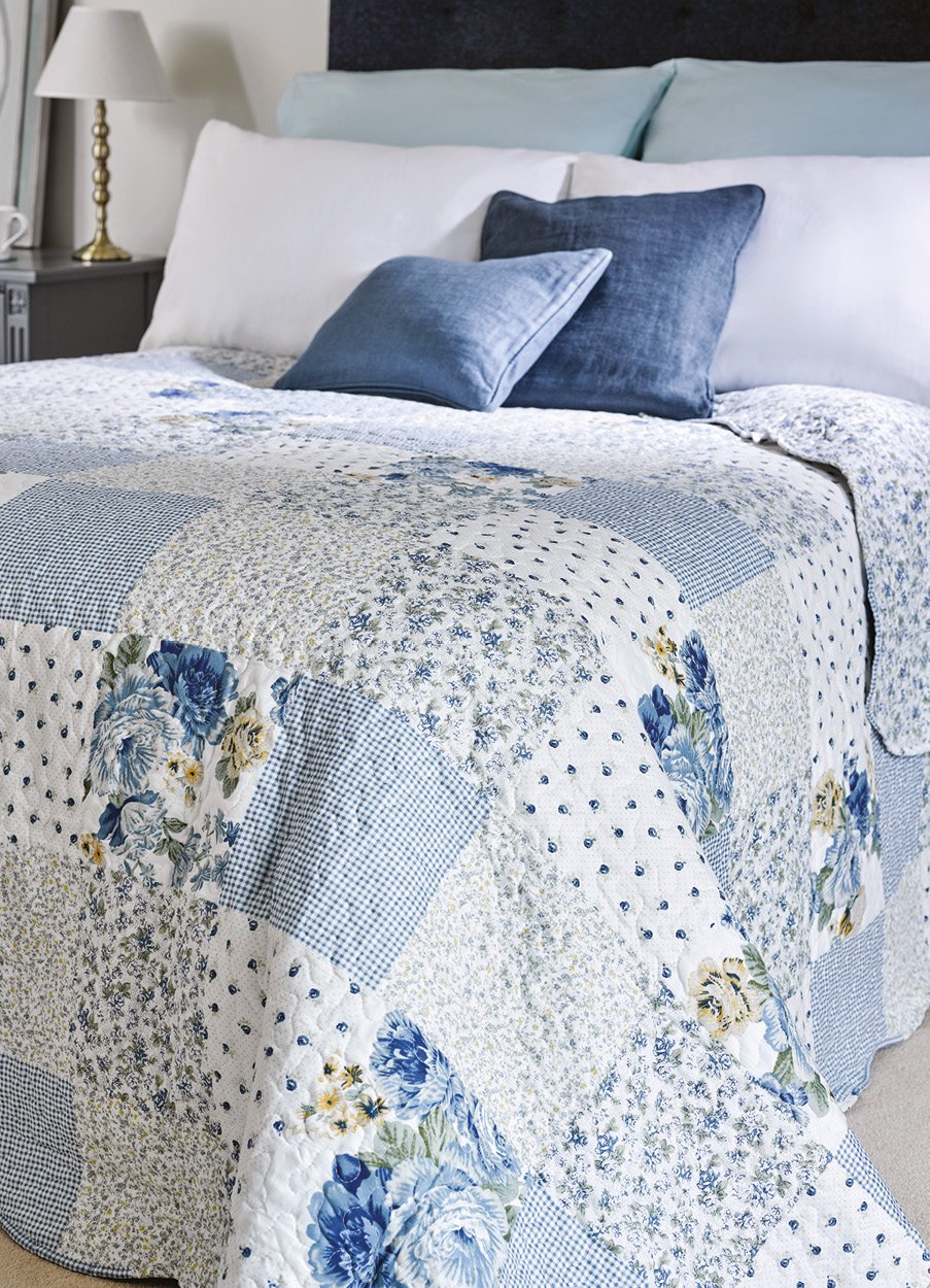 Blue patchwork bedspread on a bed