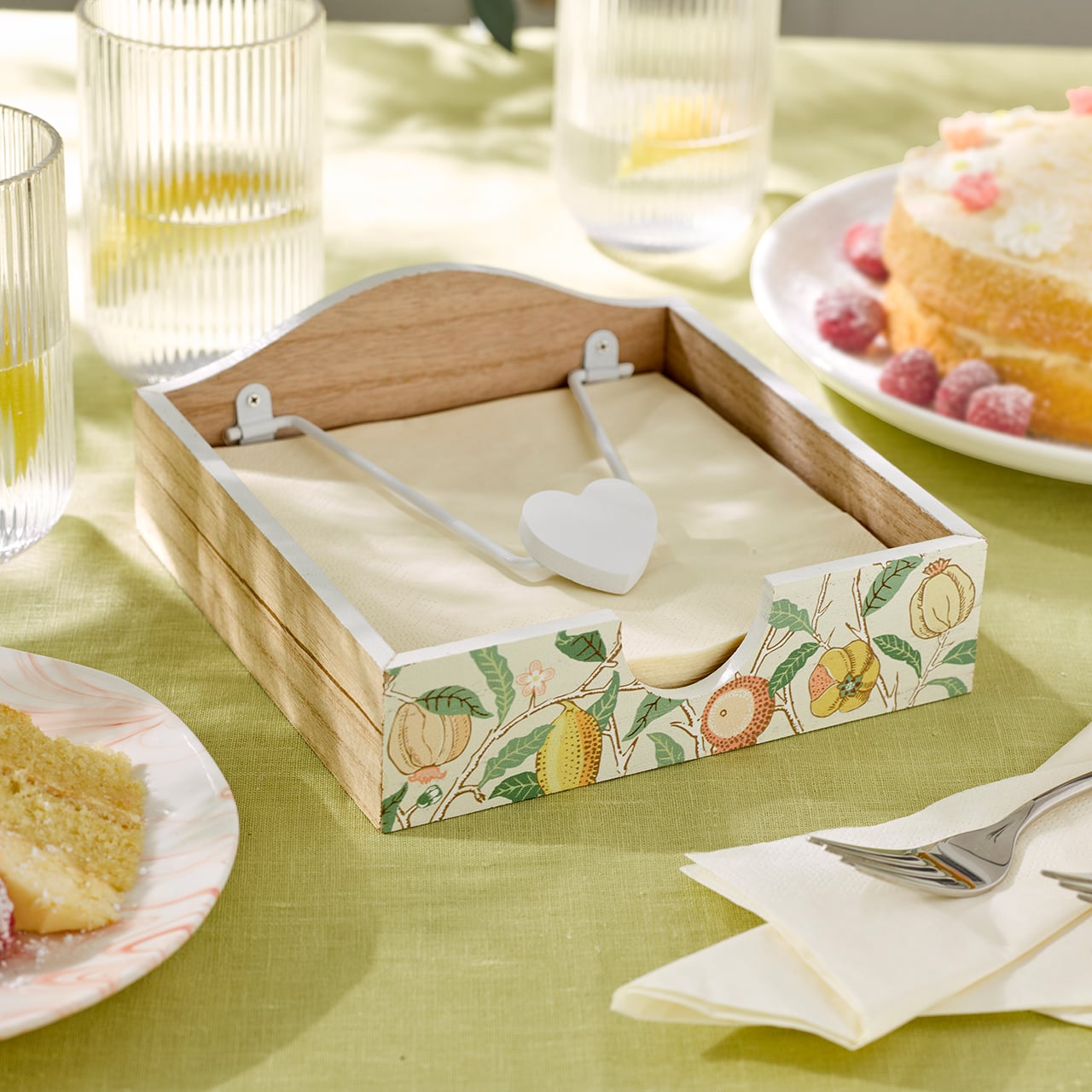 Four fruit‑patterned mugs arranged on a table