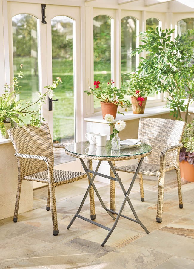 Image showing faux rattan bistro set with glass topped table inside a conservatory