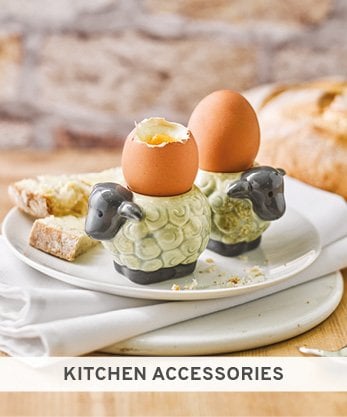 Image shows two sheep egg cups with boiled egg in